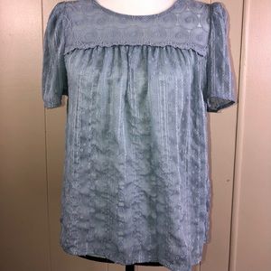 E&M woman’s blue lace shirt.